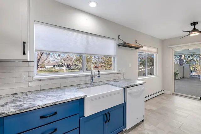 a spacious bedroom with a bed and a chandelier