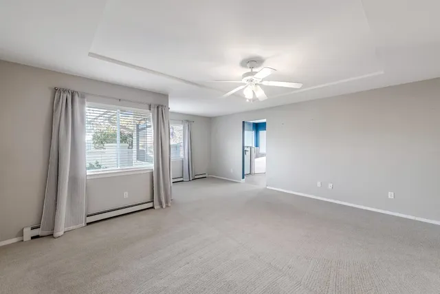 a view of a livingroom with a ceiling fan and window