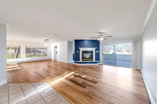 a view of an empty room with a fireplace and a window