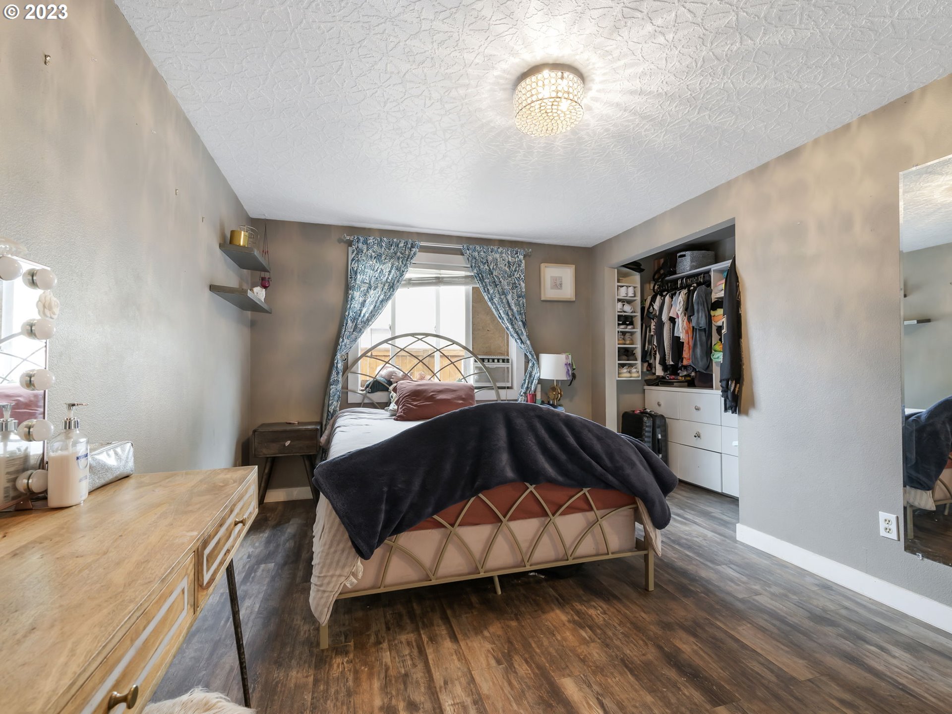 4413 Addy Loop Washougal, WA 98671 - Photo 13 of 28 a bedroom with a bed and a chandelier