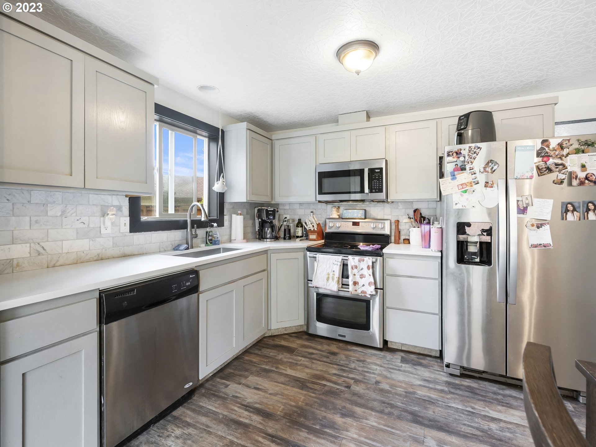 4413 Addy Loop Washougal, WA 98671 - Photo 7 of 28 a kitchen with a sink cabinets and stainless steel appliances