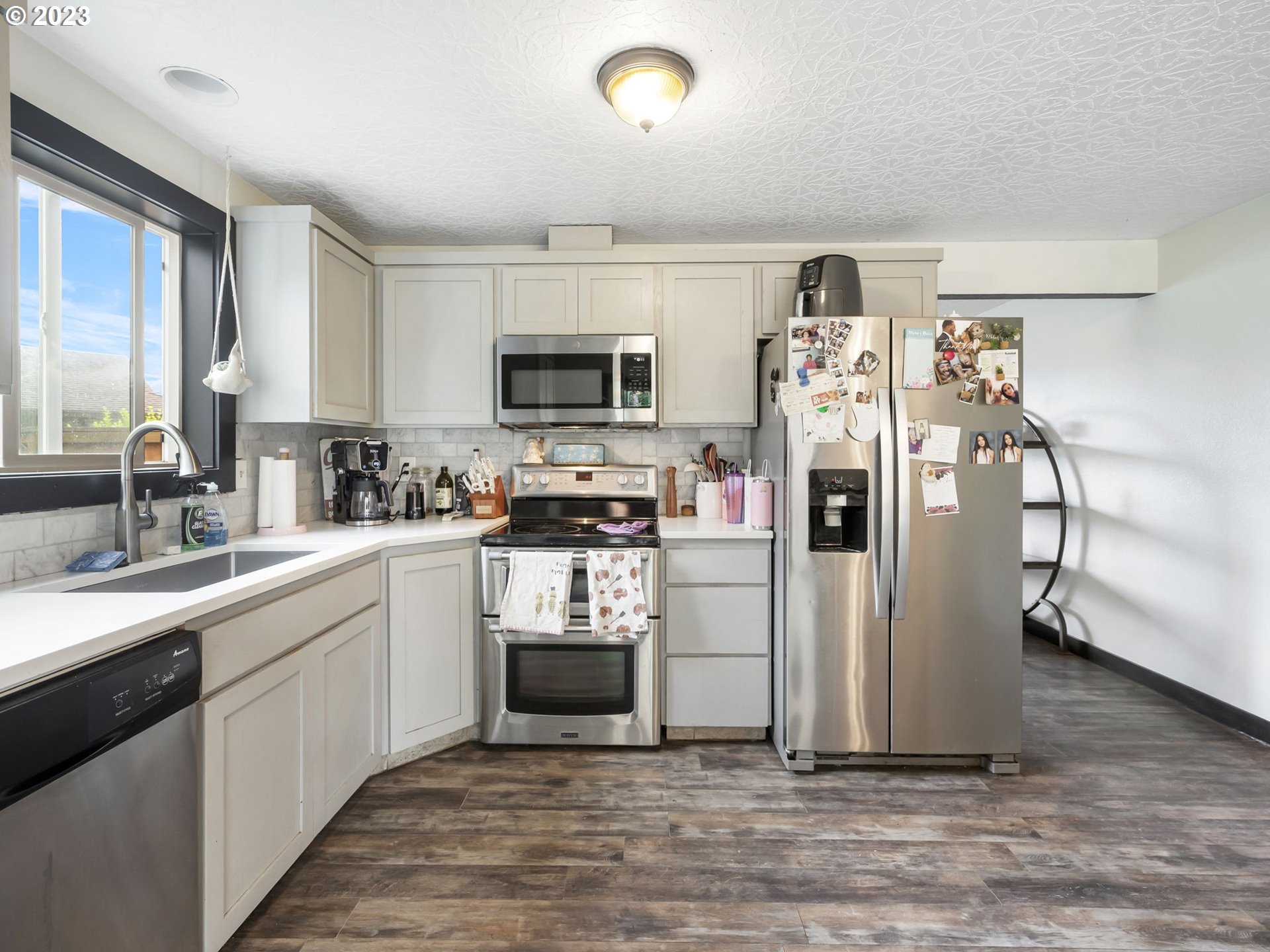4413 Addy Loop Washougal, WA 98671 - Photo 8 of 28 a kitchen with a sink stainless steel appliances and cabinets
