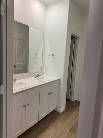 a bathroom with a double vanity sink and mirror