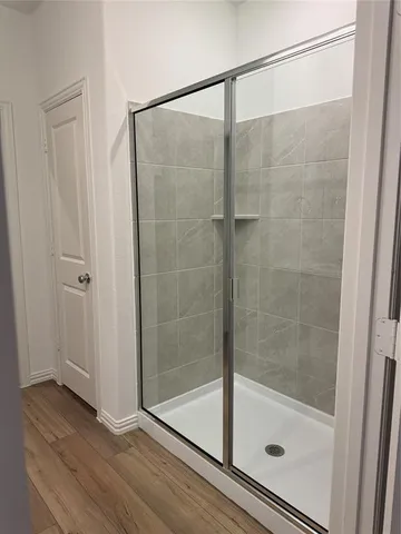 a bathroom with a glass shower door