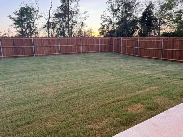 a view of a yard with a fence