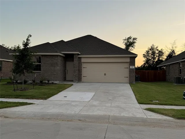 a front view of house with a yard and garage