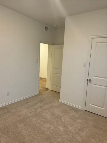 an empty room with closet area