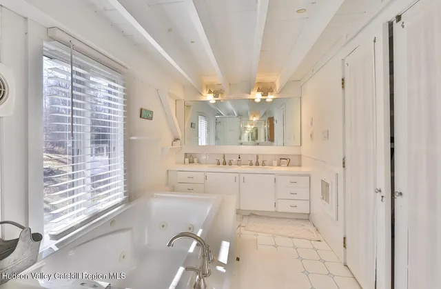 a bathroom with a sink a vanity and a mirror