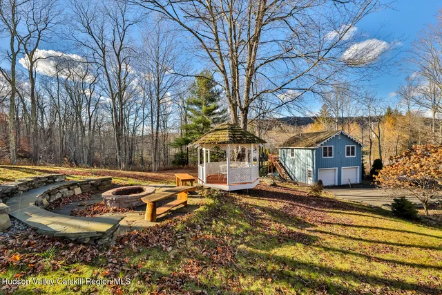a view of a house with pool and sitting area