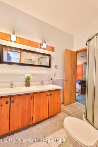 a spacious bathroom with a sink a mirror and a bathtub