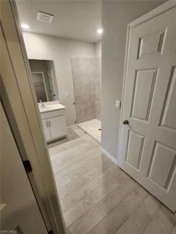 a spacious bathroom with a double vanity sink and a mirror