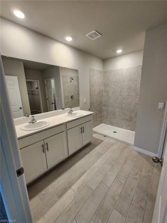 2320 Thurlow Street Alva, FL 33920 - Photo 5 of 11 a spacious bathroom with a double vanity sink and a mirror