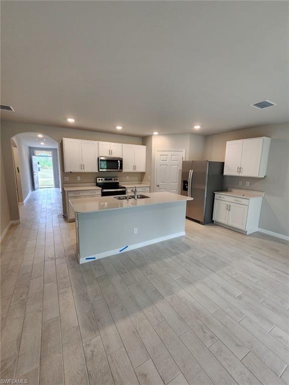 2320 Thurlow Street Alva, FL 33920 - Photo 7 of 11 a view of kitchen with refrigerator stove microwave and cabinets