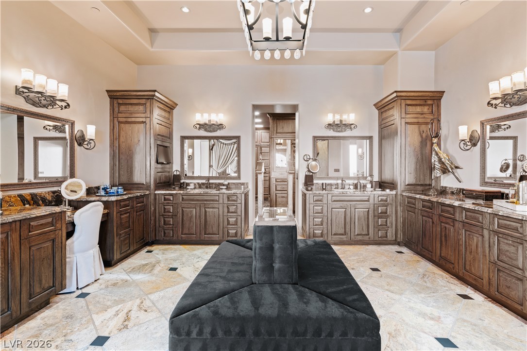 1123 Christian Road Henderson, NV 89002 - Photo 28 of 94 Luxurious dual vanities, intricate cabinetry, and polished flooring define this opulent primary bathroom.