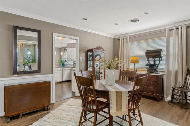 a view of a dining room with furniture and window