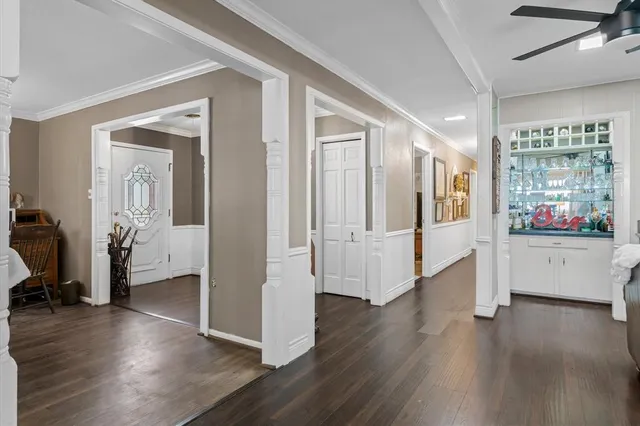 a view of a big room with wooden floor and windows