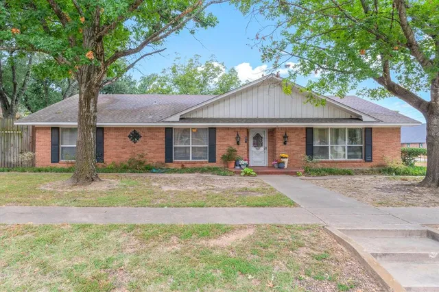 a front view of a house with a garden and patio
