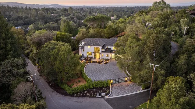 an aerial view of a house with a yard basket ball court and outdoor seating