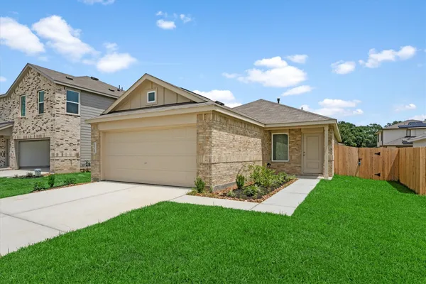 a front view of a house with a garden and yard