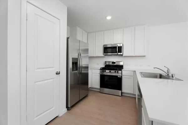 a kitchen with a refrigerator stove and a sink