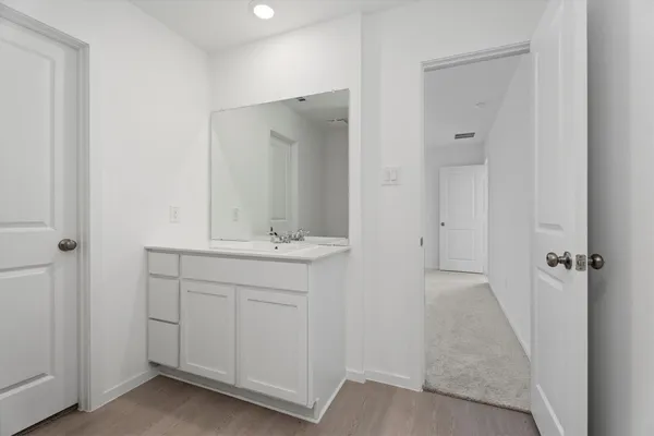 a bathroom with a sink and mirror