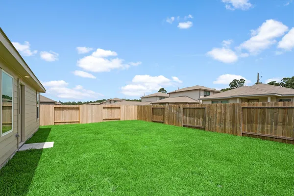 a view of a house with a yard and sitting area
