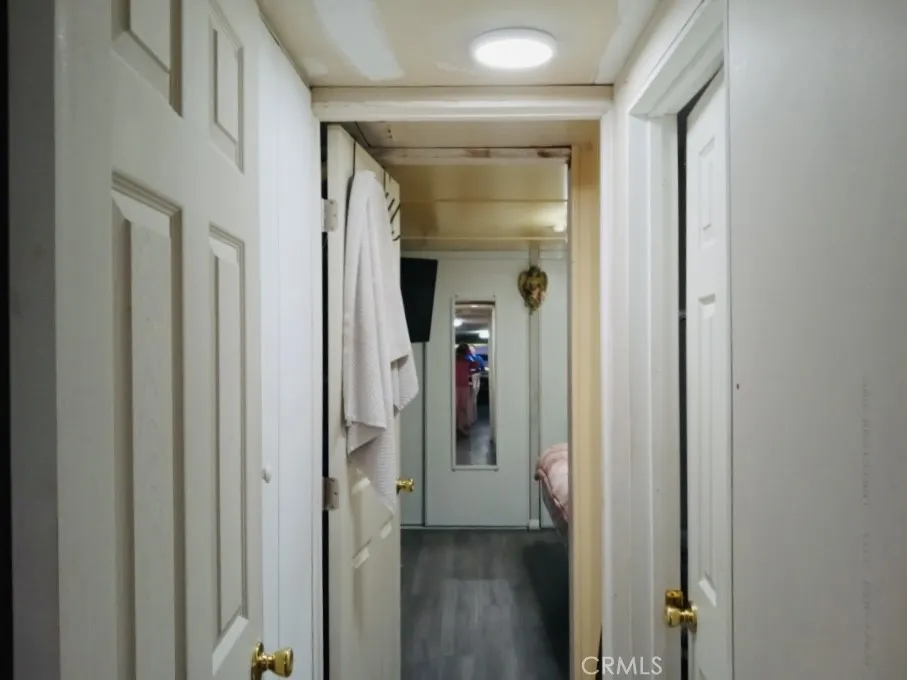 26235 East 9th, Unit 36 Highland, CA 92346 - Photo 12 of 15 a view of a hallway with wooden floor and closet
