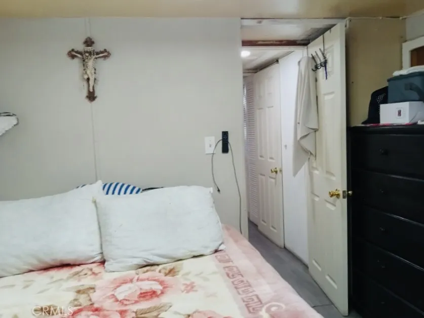 26235 East 9th, Unit 36 Highland, CA 92346 - Photo 14 of 15 a bedroom with a bed and a walk in closet