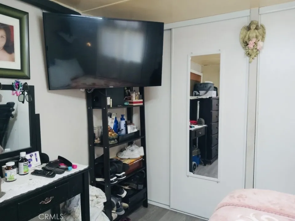 26235 East 9th, Unit 36 Highland, CA 92346 - Photo 15 of 15 a bedroom with a bed and a desk