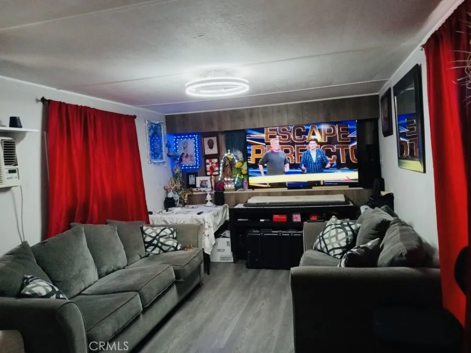 26235 East 9th, Unit 36 Highland, CA 92346 - Photo 5 of 15 a living room with furniture a flat screen tv and a couch