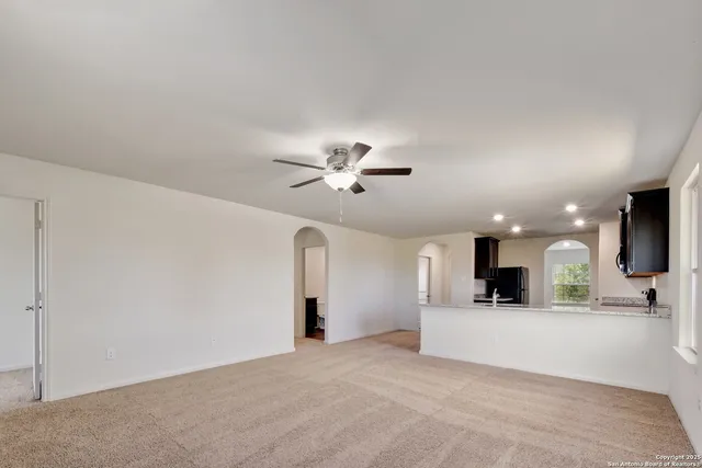 a view of a kitchen with a sink and a chandelier fan