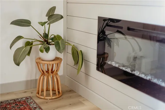 a kitchen with a sink dishwasher and cabinets with wooden floor
