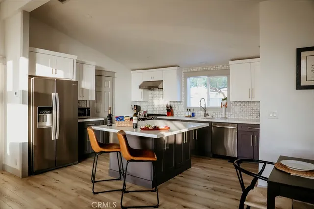 a kitchen with stainless steel appliances a sink stove and cabinets