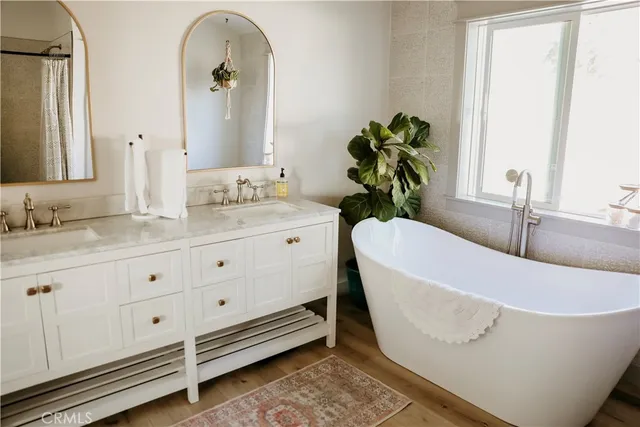 a bed sitting in a bedroom next to a lamp with a chair