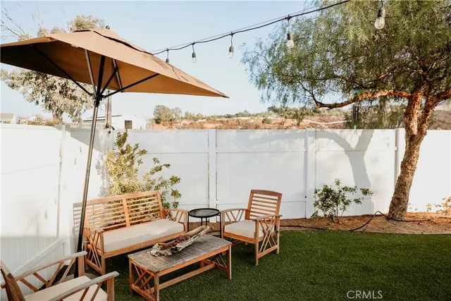 a backyard of a house with outdoor seating