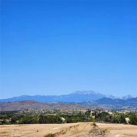 a large bed sitting in a bedroom next to a window