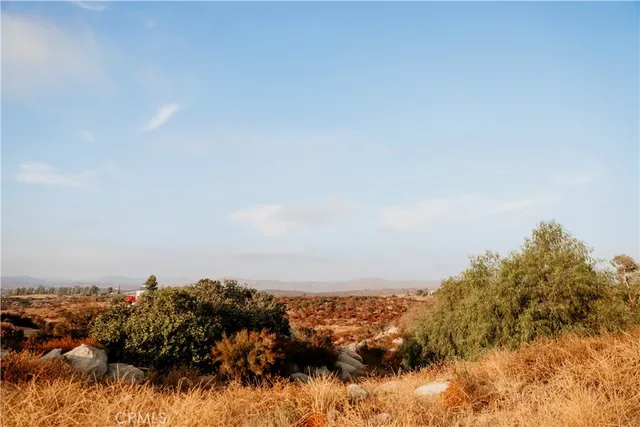 a hallway with white cabinets and black stainless steel appliances