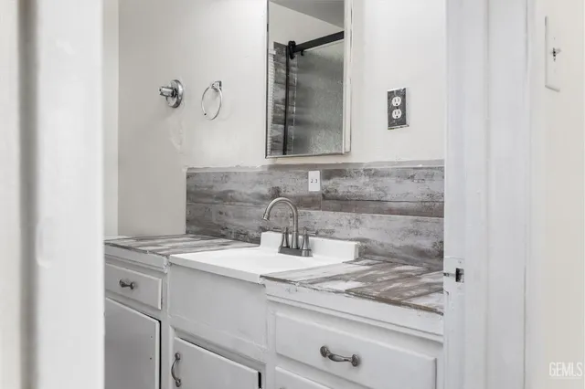 a bathroom with a sink and a mirror