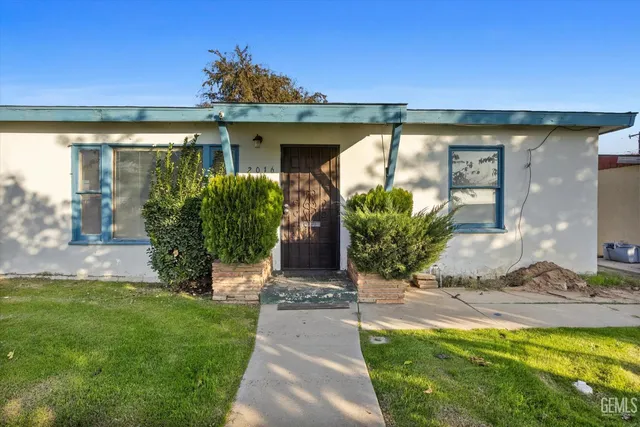 a front view of a house with garden