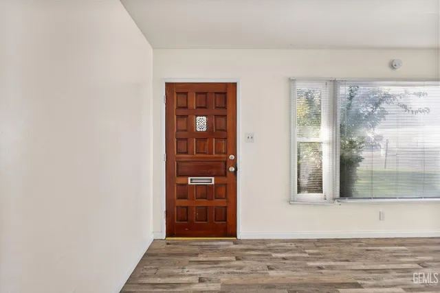 a view of a livingroom with wooden floor and a window