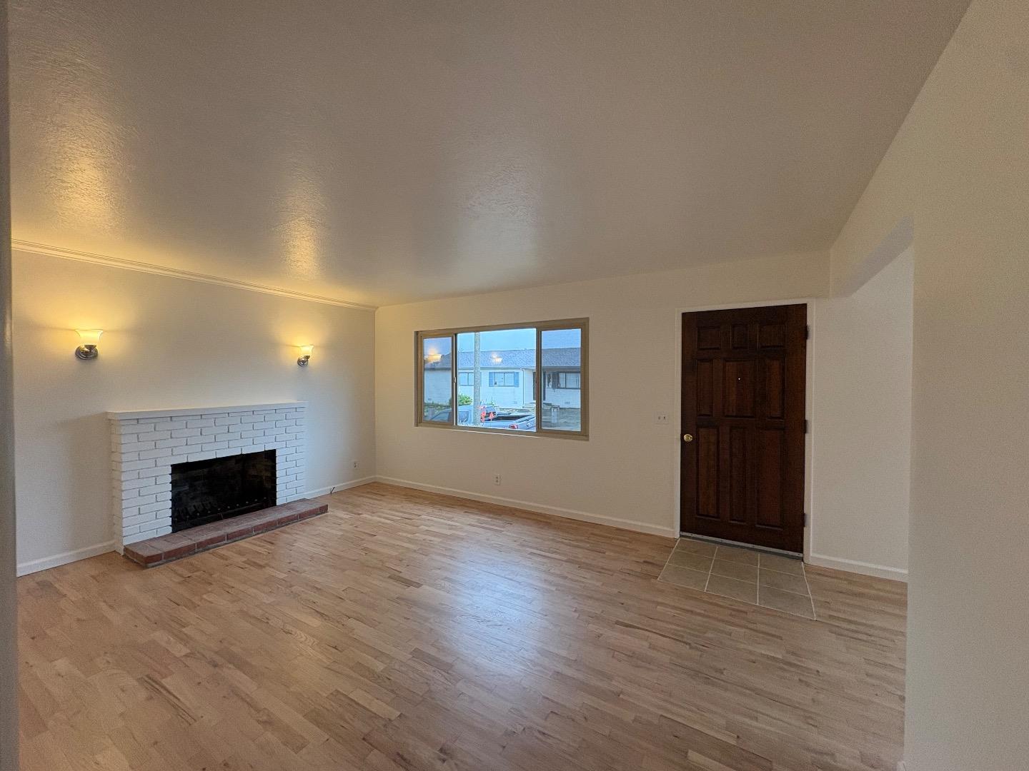 1675 Luxton Street Seaside, CA 93955 - Photo 15 of 33 wooden floor fireplace and windows in an empty room