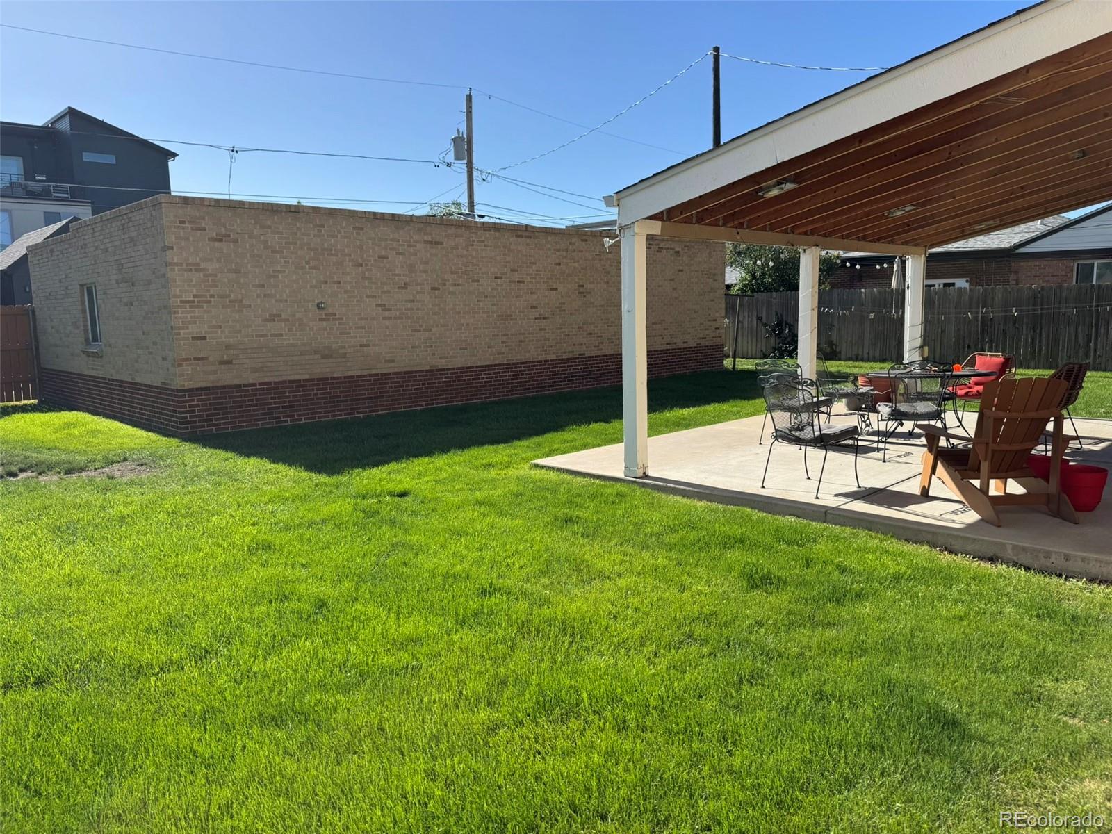2050 Perry Street Denver, CO 80212 - Photo 10 of 15 a view of a patio with table and chairs and a large tree