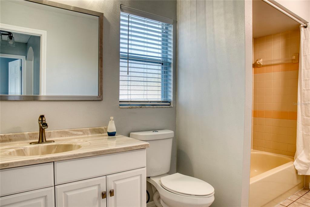 1447 Kingston Way Kissimmee, FL 34744 - Photo 15 of 24 a bathroom with a sink a toilet and shower
