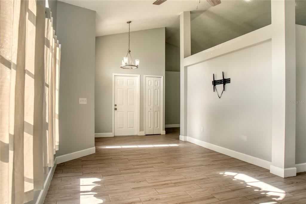1447 Kingston Way Kissimmee, FL 34744 - Photo 4 of 24 a view of an empty room with wooden floor