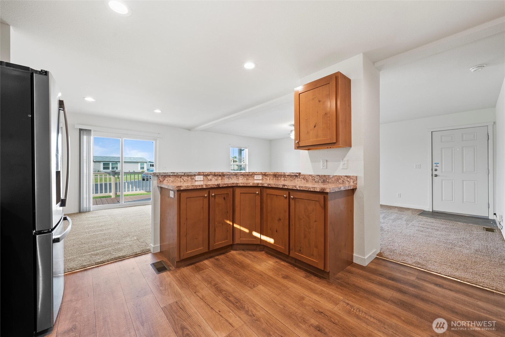 1701 Burr Avenue, Unit 51 Moses Lake, WA 98837 - Photo 14 of 35 a kitchen with granite countertop a refrigerator and a stove top oven