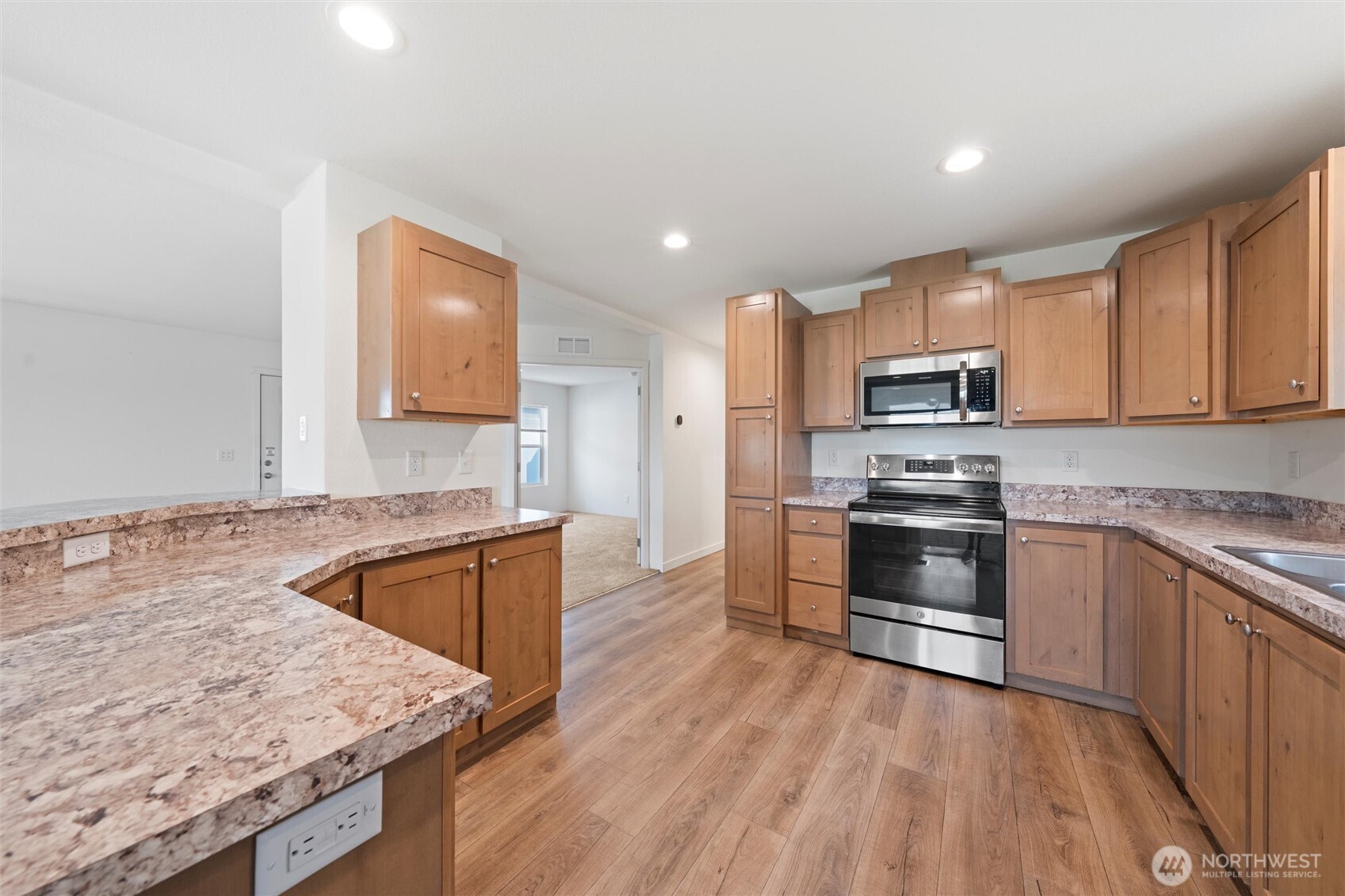 1701 Burr Avenue, Unit 51 Moses Lake, WA 98837 - Photo 15 of 35 a kitchen with stainless steel appliances granite countertop a sink stove microwave and cabinets