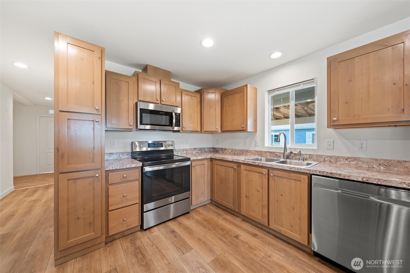 1701 Burr Avenue, Unit 51 Moses Lake, WA 98837 - Photo 16 of 35 a kitchen with granite countertop stainless steel appliances and wooden cabinets