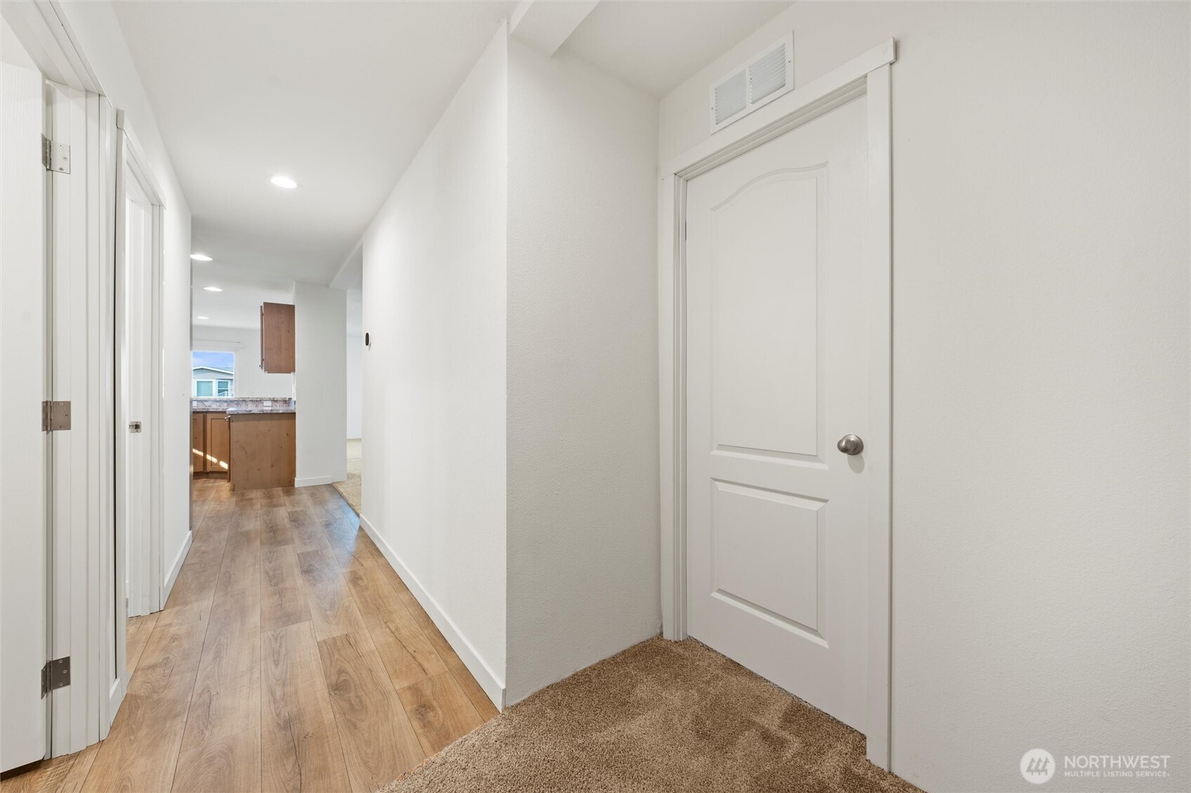 1701 Burr Avenue, Unit 51 Moses Lake, WA 98837 - Photo 23 of 35 a view of a hallway with wooden floor