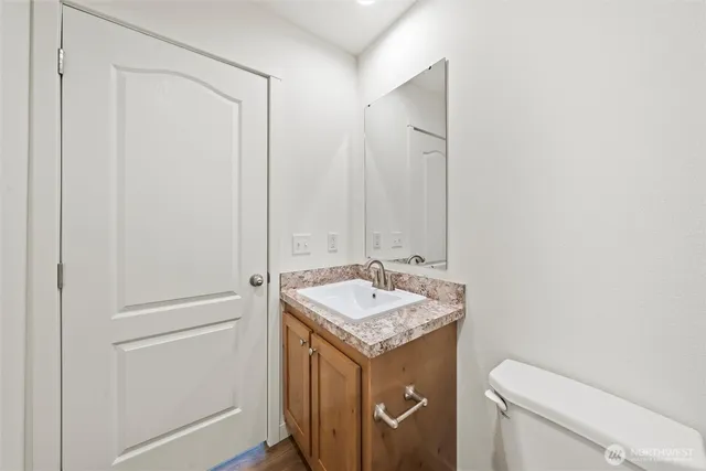 a bathroom with a granite countertop sink and a mirror