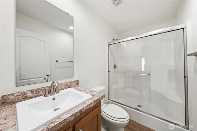 a bathroom with a sink a mirror and a toilet